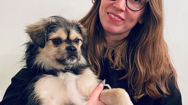 Max and Sarah having a cuddle - Sarah is smiling, Max isn't so sure